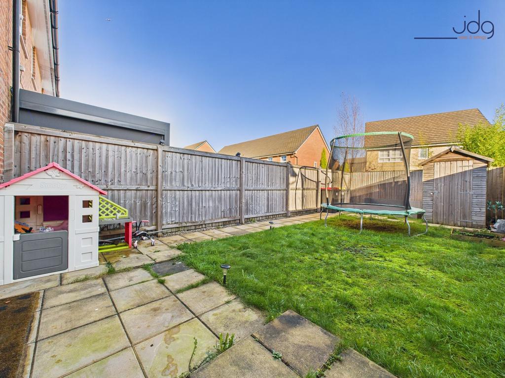 A spacious garden incorporating a mix of lawn...