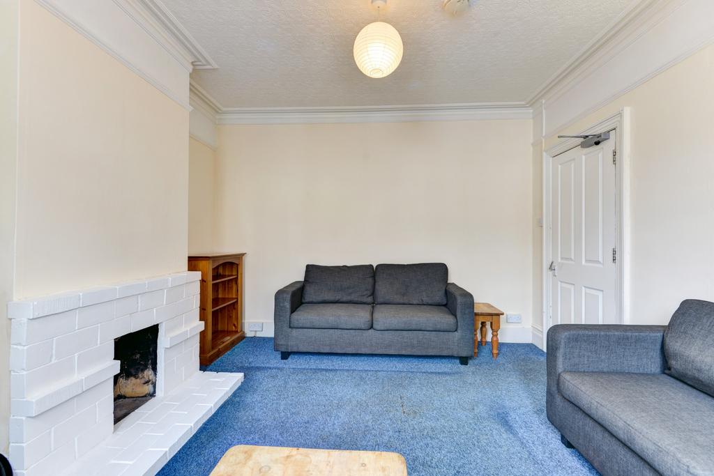 A comfortably furnished living room featuring a...
