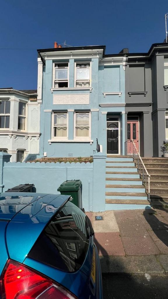 A clear view of a charming terraced house with ...
