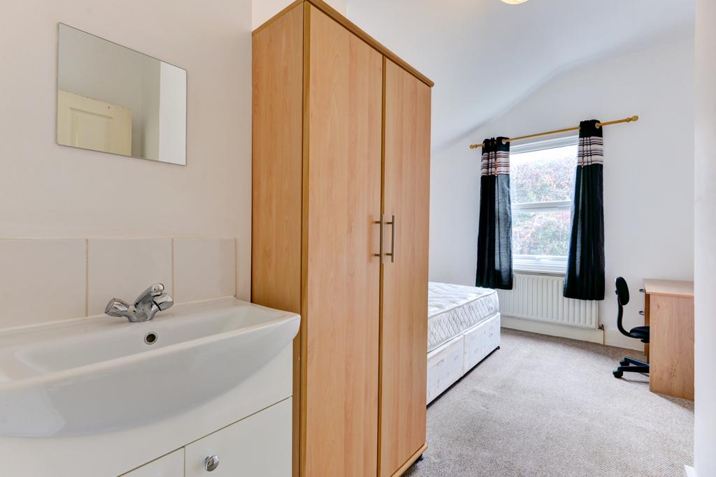 Bright, neatly presented bedroom with a comfort...