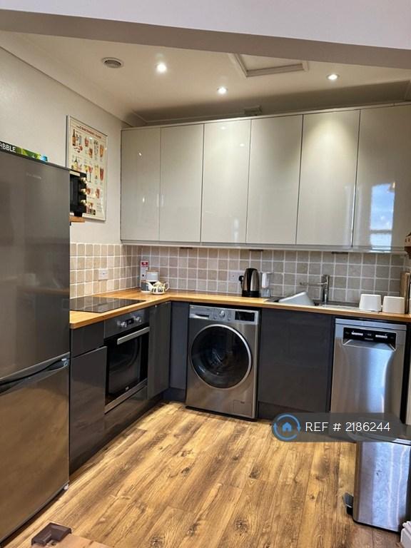 Kitchen w/ Fitted Cupboards And Modern Appliances