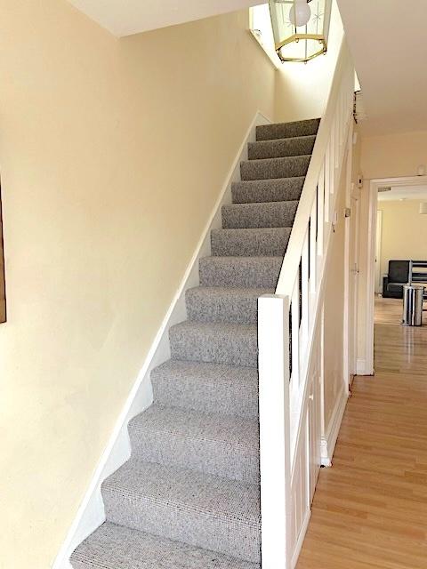 Bright, well-maintained entrance with carpeted ...