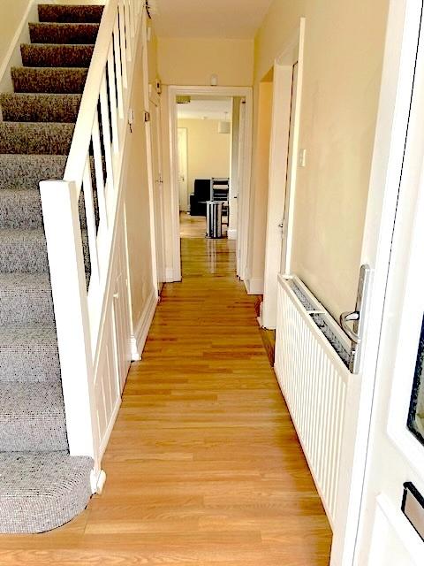 Bright entrance hallway with wood-effect floori...