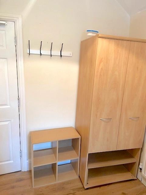 Bright, simply furnished bedroom corner with li...
