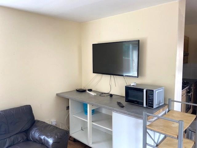 Bright, simply furnished living area with a wal...