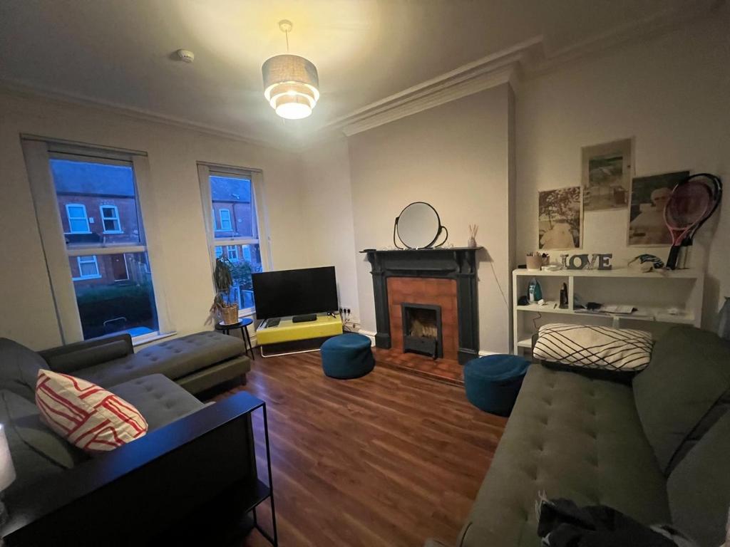 Comfortable living room with hardwood floors, d...