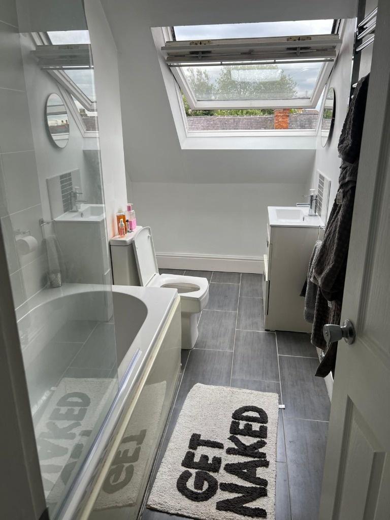 Bright, modern bathroom with a fitted bathtub, ...