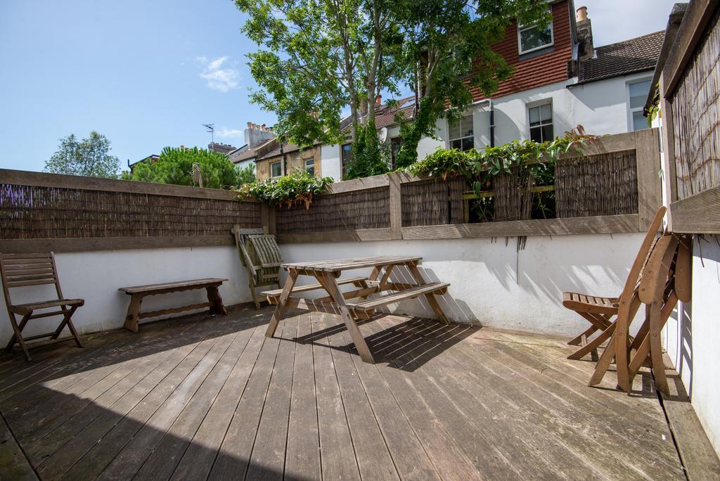 Sunny private enclosed patio with wooden deckin...