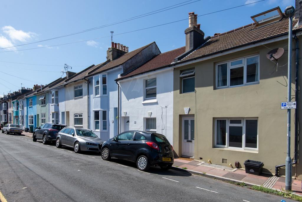 Row of well-maintained terraced houses on a sun...