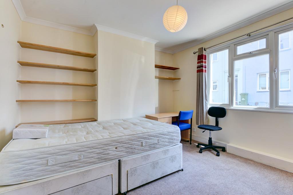 Bright furnished bedroom with two single beds p...