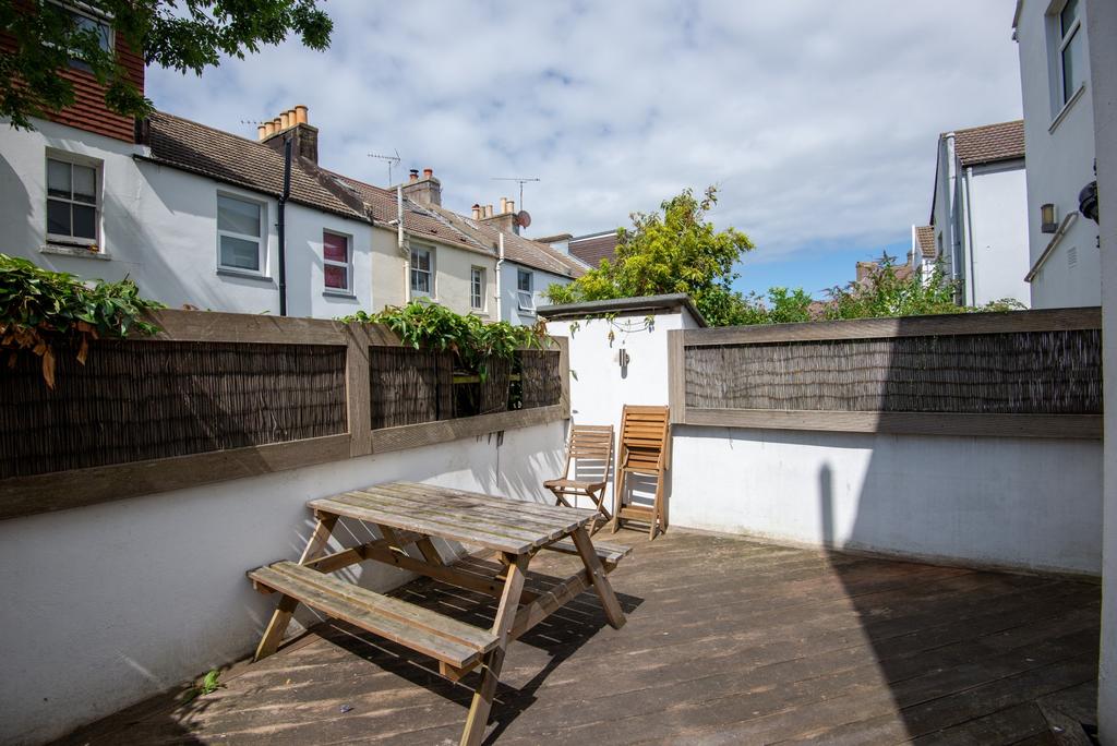 Sunny enclosed rear garden with a timber deck, ...