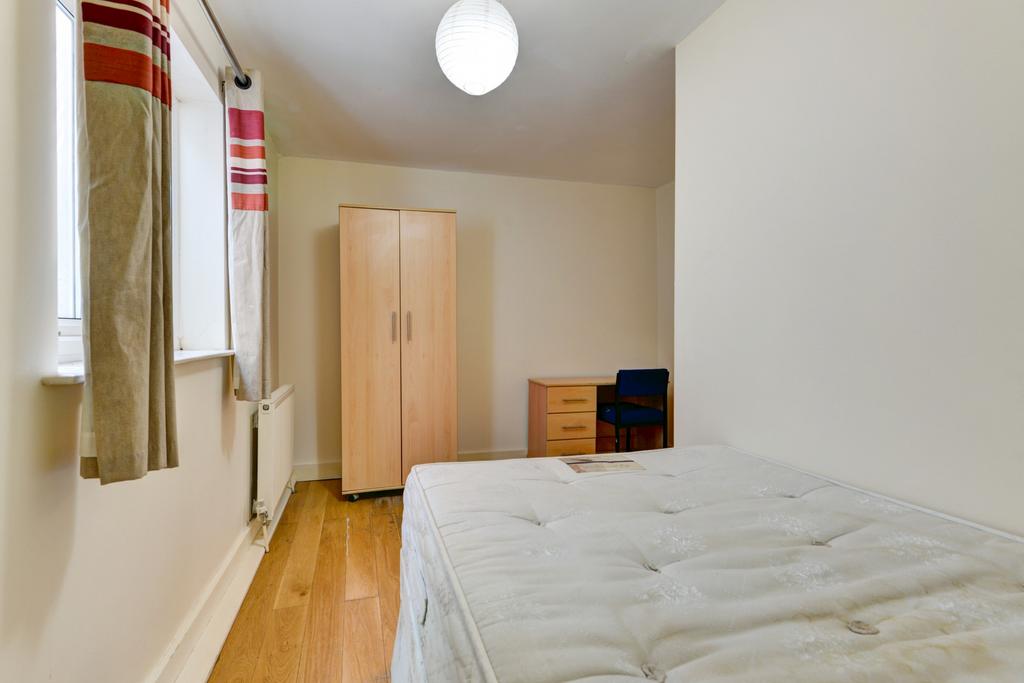 Bright and inviting bedroom featuring a comfort...