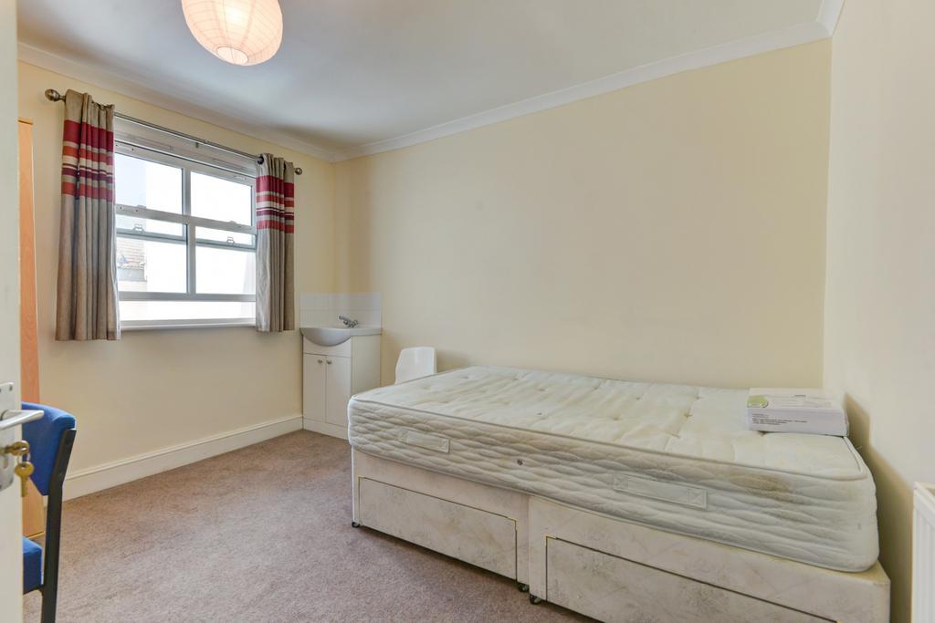 Bright, simply furnished single bedroom with a ...