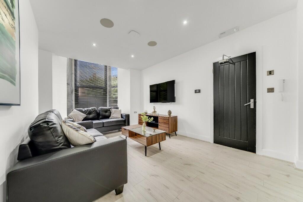 A modern, bright living room with large windows...