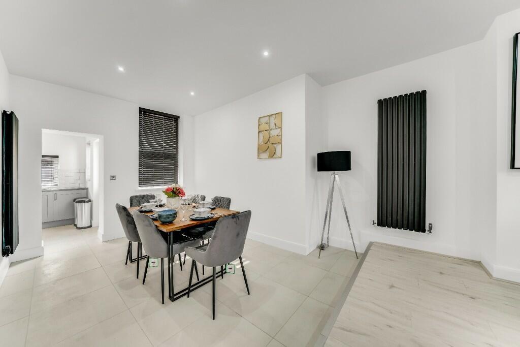 A modern and spacious living room with bright w...