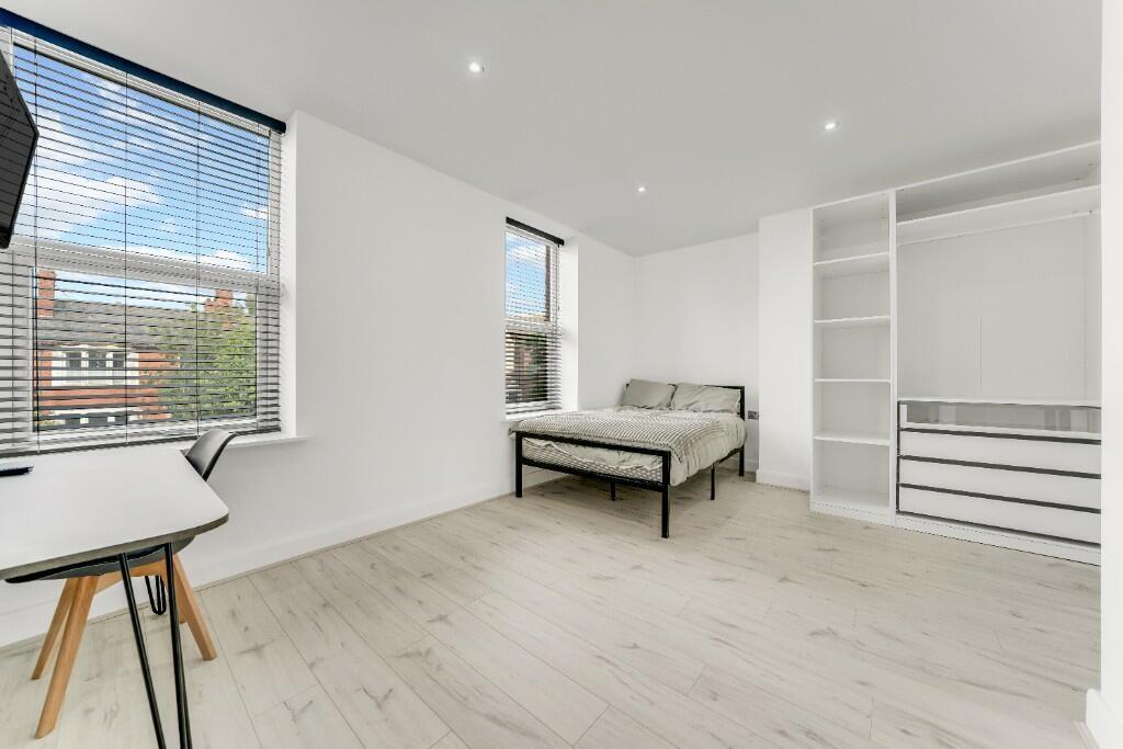 Bright and spacious living room with ample natu...