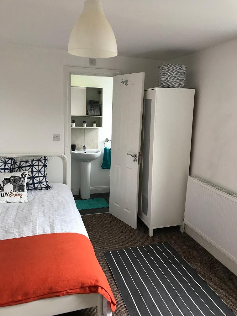 Bright, neatly presented bedroom with a comfort...