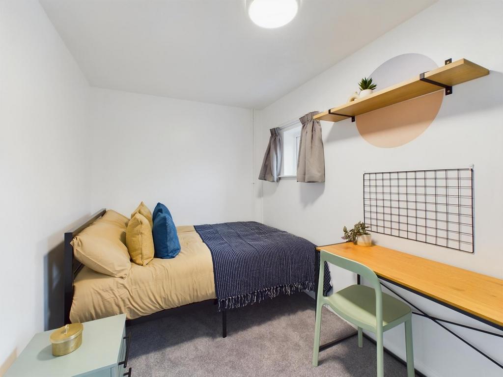 A bright and inviting double bedroom featuring ...