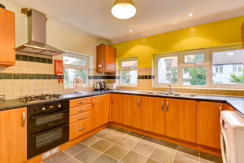 Bright, well-equipped kitchen with generous cou...