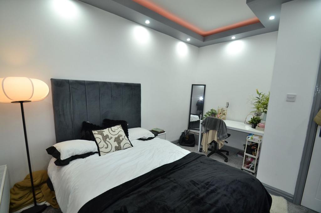 Bright, modern bedroom with a plush upholstered...