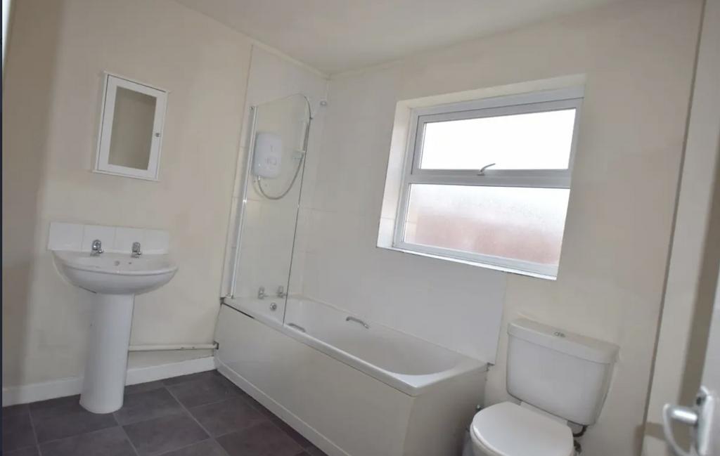 Bright, neutral bathroom with a full bathtub an...