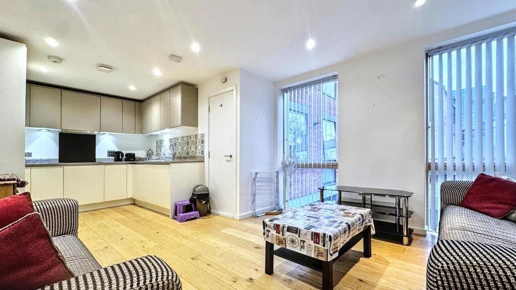 Bright open-plan living area with a modern fitt...