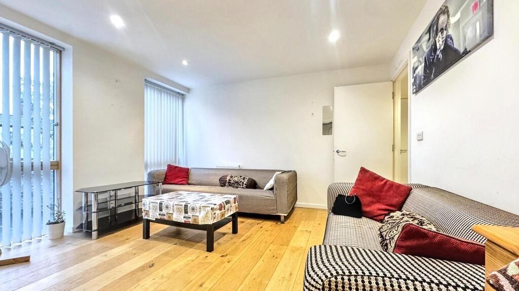 Bright contemporary living room with wooden flo...