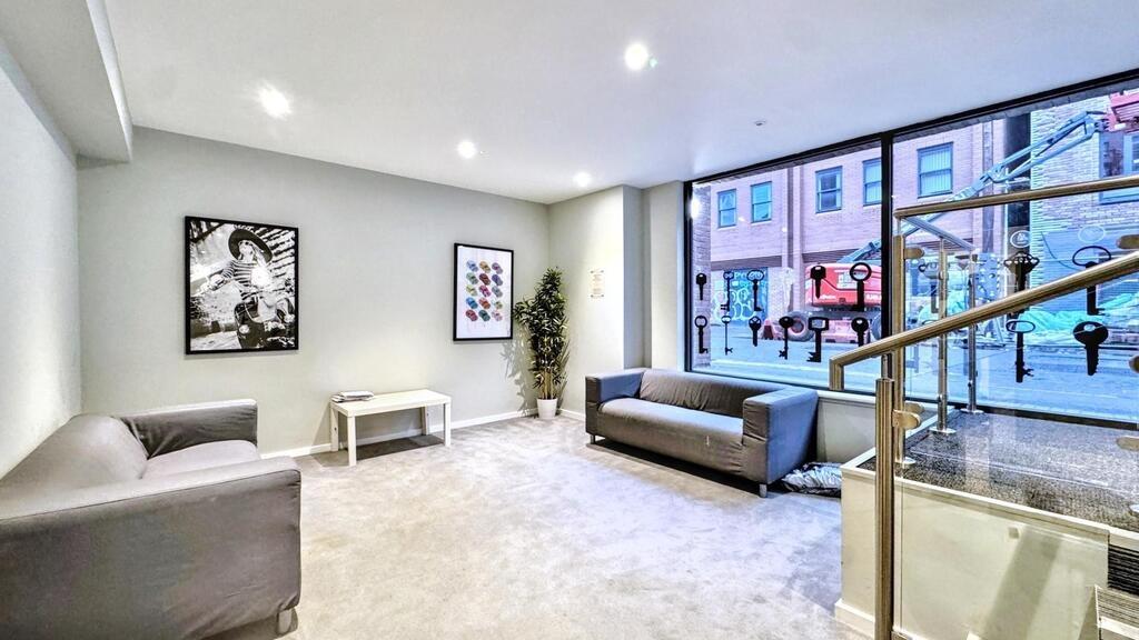 Bright, modern communal lounge with comfortable...