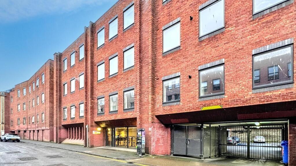 Well-maintained brick apartment building with s...