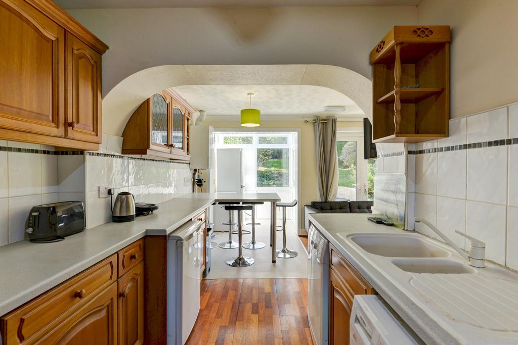 Bright and welcoming kitchen with ample natural...