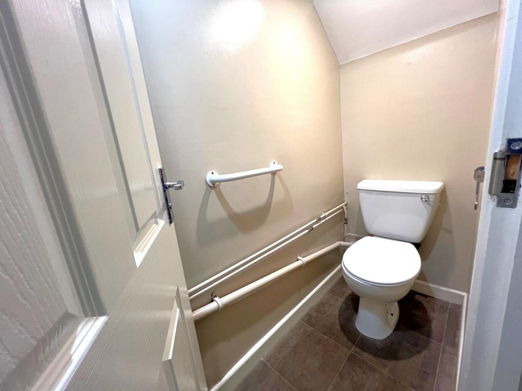 Compact, well-maintained WC with modern white t...