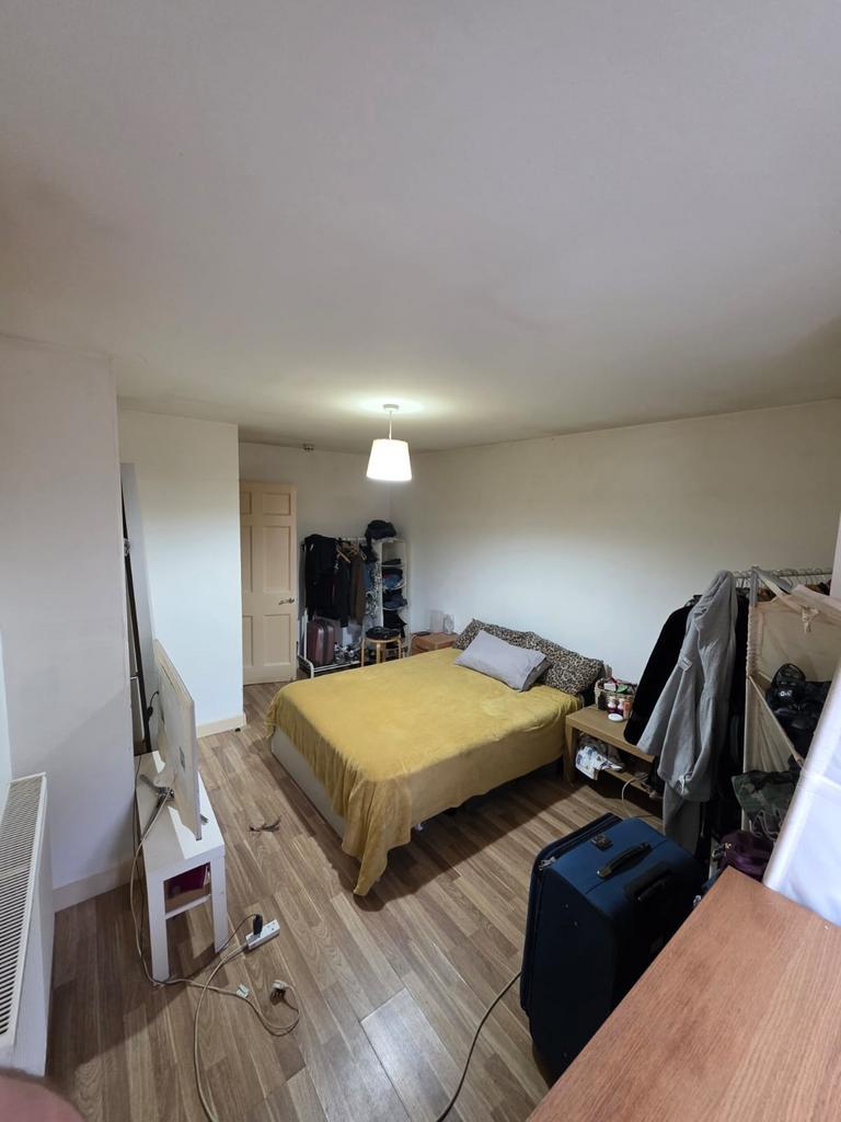 Bright double bedroom with wooden flooring, cen...
