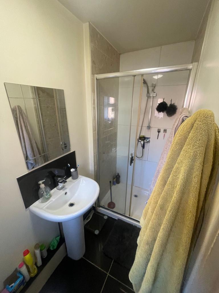 Compact, well-maintained bathroom with a corner...