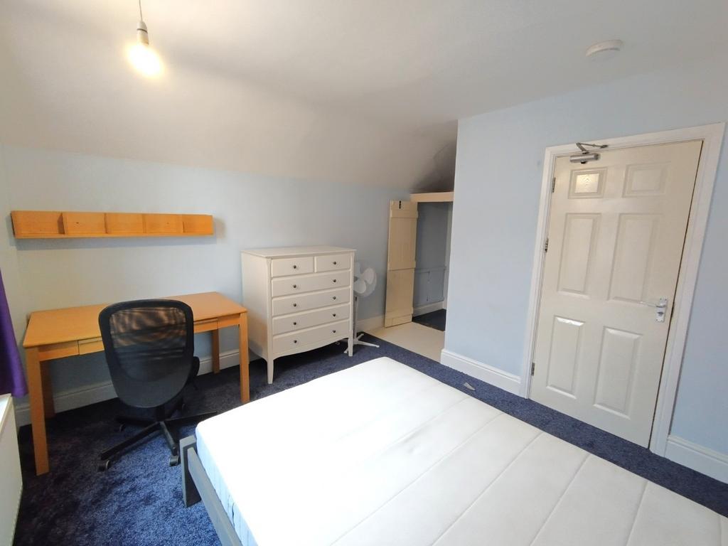 Bright, neatly presented bedroom with a comfort...