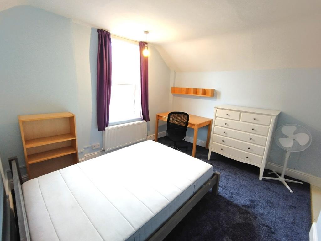 Bright, neatly presented bedroom with a large w...