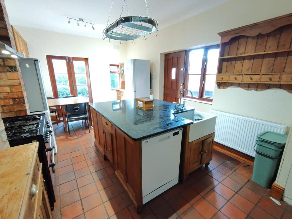 Bright country-style kitchen with a central isl...