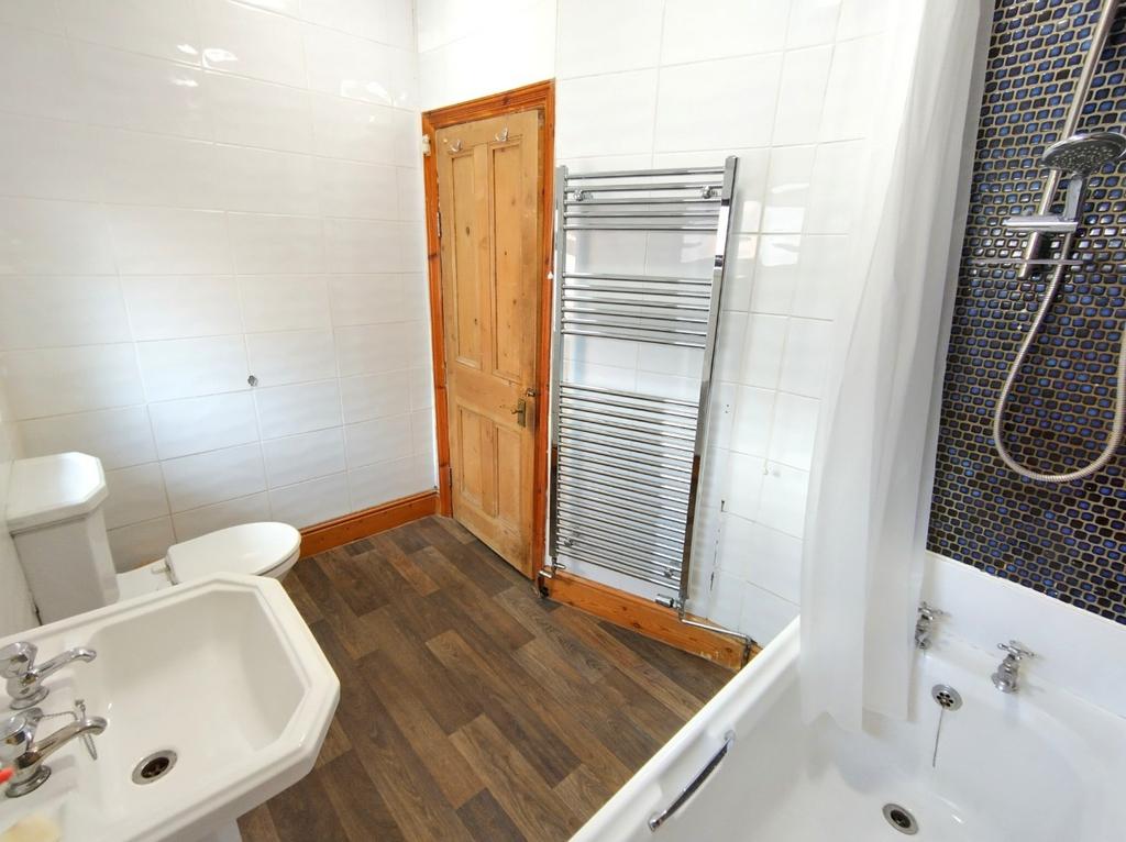 Bright, modern bathroom with a classic white si...