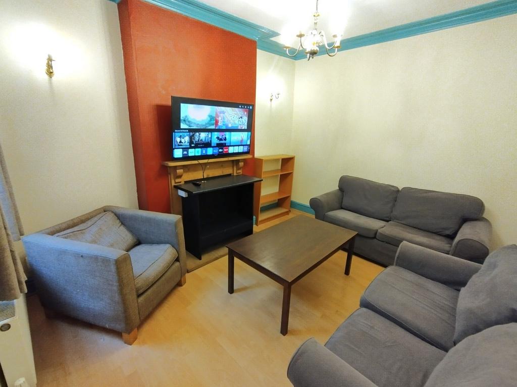 Warm, well-furnished living room with comfortab...