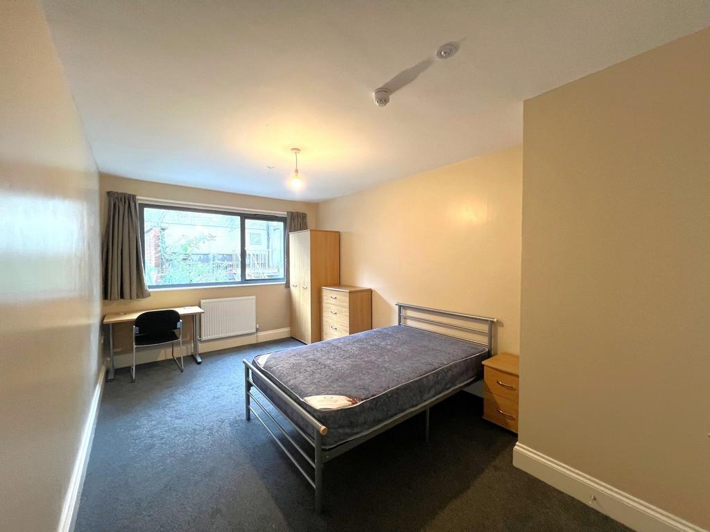 Bright, well-presented bedroom with a large win...