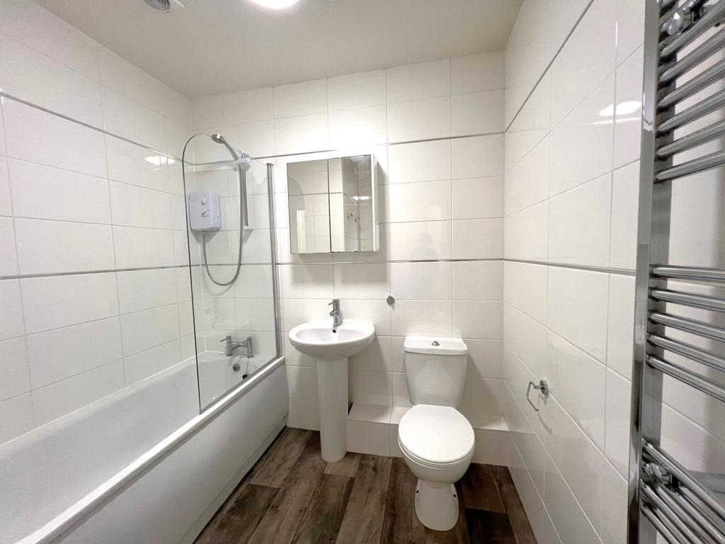 Bright, modern bathroom with a full bath and sh...