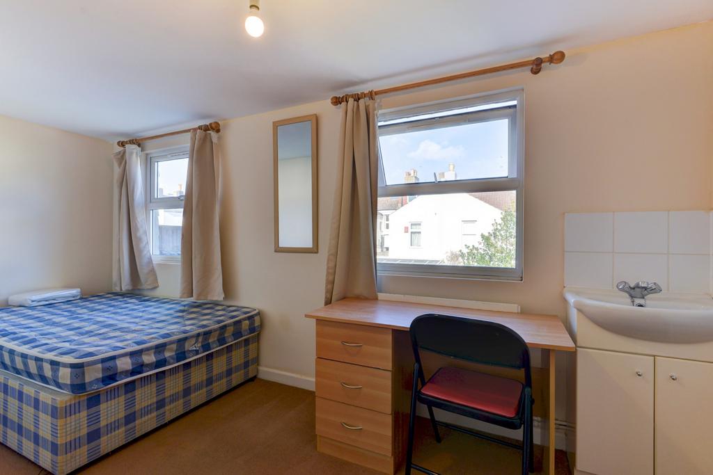 Bright, simply furnished double bedroom with a ...