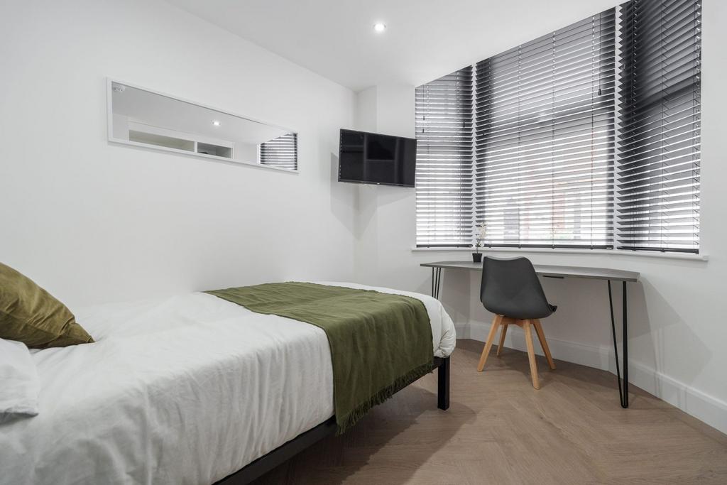 A modern and minimalistic bedroom featuring a s...