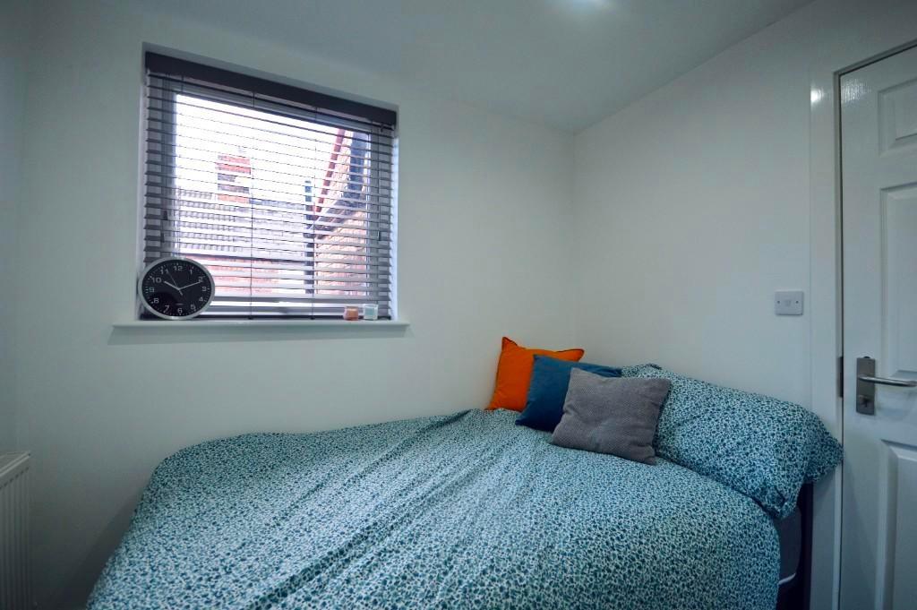 A bright and inviting double bedroom featuring ...