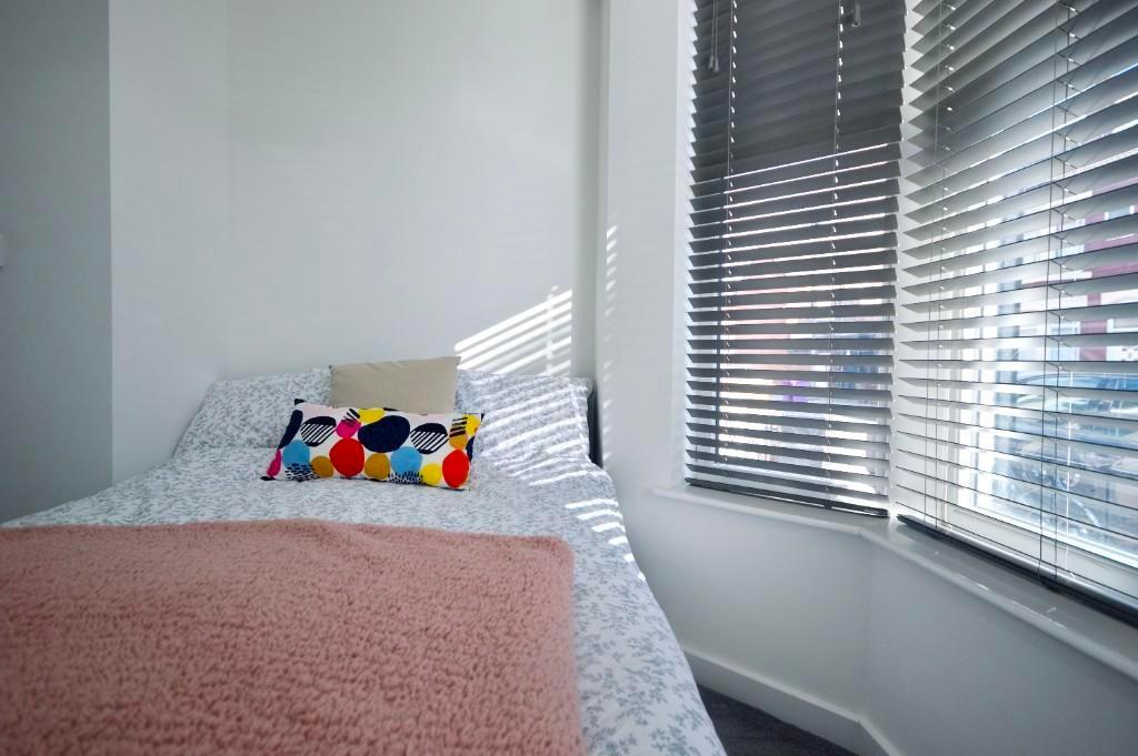 A clean and inviting small bedroom featuring a ...