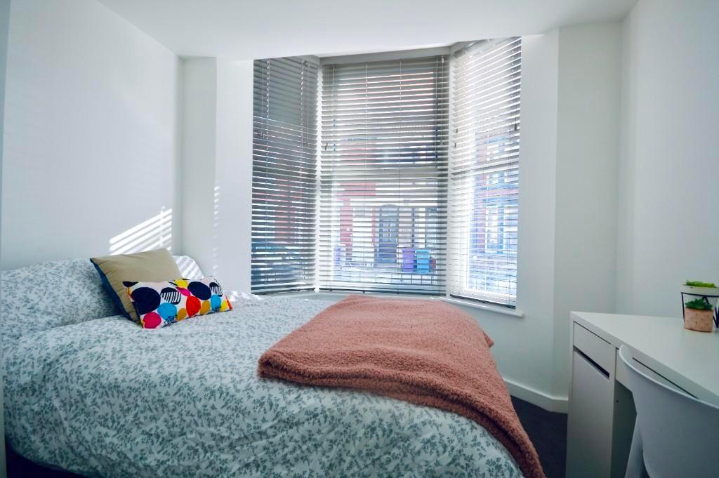 A bright and inviting bedroom filled with natur...