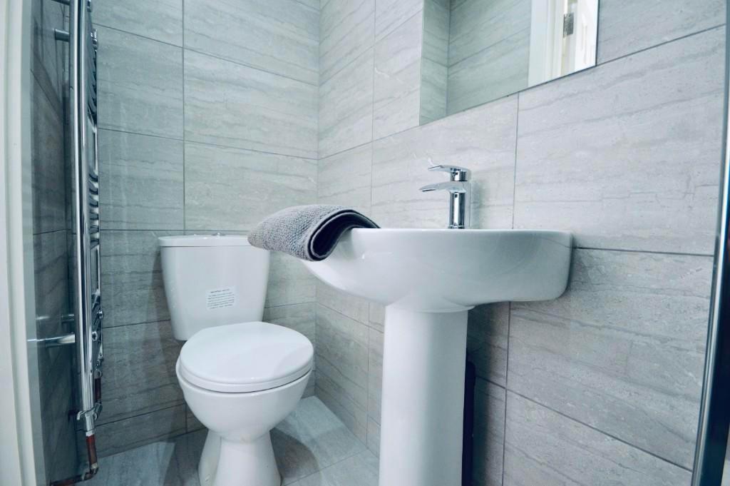 A clean, well-maintained bathroom featuring a m...