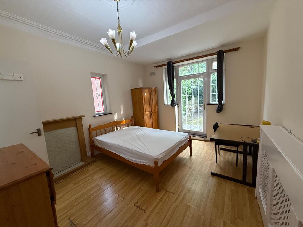 Bright, unfurnished double bedroom with timber ...