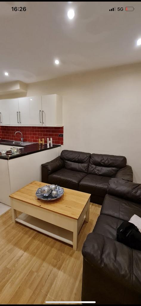 Comfortable living area with two leather sofas,...