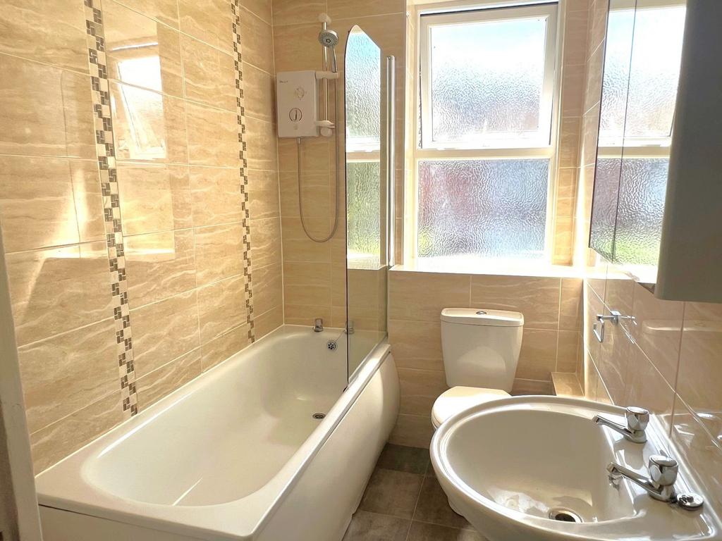 Bright, modern bathroom with a full bath and ov...