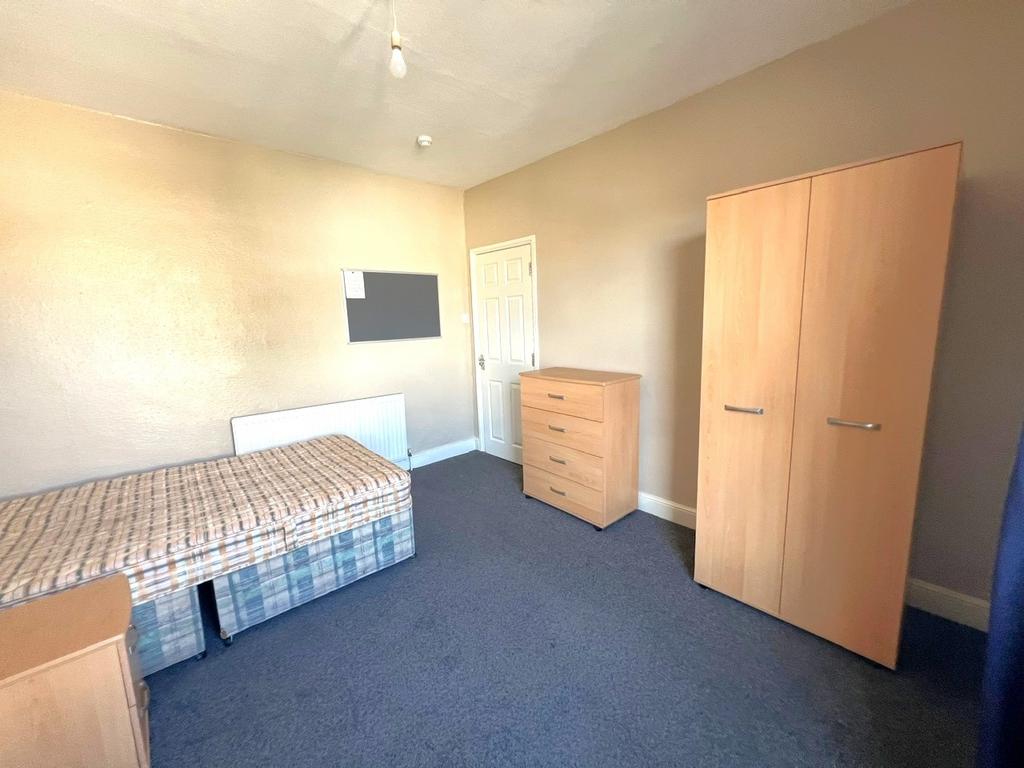 Bright, simply furnished single bedroom with a ...